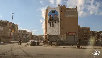 Wide view of a public mural painted in Raqqa