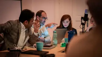 Workshop participants reviewing project material on laptops in Berlin