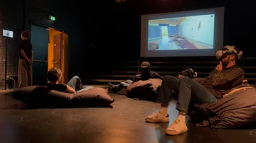 Visitors using virtual reality during the Sednaya exhibition in Hanover