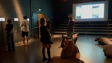 Visitors exploring testimony stations and virtual reality in the Sednaya exhibition in Hanover