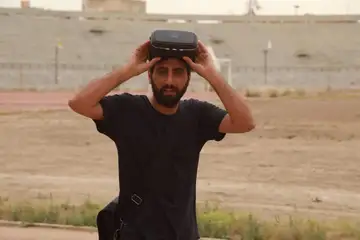 Amer Matar testing a virtual-reality reconstruction at Raqqa Municipal Stadium