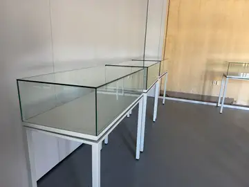 Empty glass display cases during installation of the Sednaya exhibition in Berlin