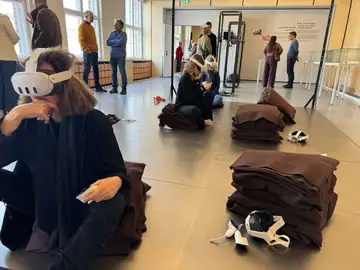 Visitors using virtual-reality headsets during a public tour of the Sednaya exhibition in Berlin
