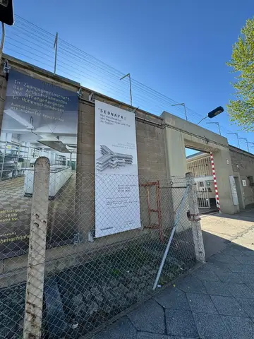 Exterior entrance to the Berlin-Hohenschönhausen Memorial with the Sednaya exhibition banner